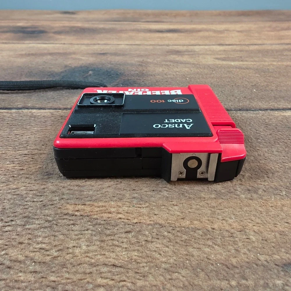 Ansco Cadet Disc 100 Camera Mens OS Red Excellent Beefeater Gin Promotional 80s